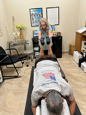 Chiropractor Las Vegas NV Cheryle Pettigrew Adjusting Legs